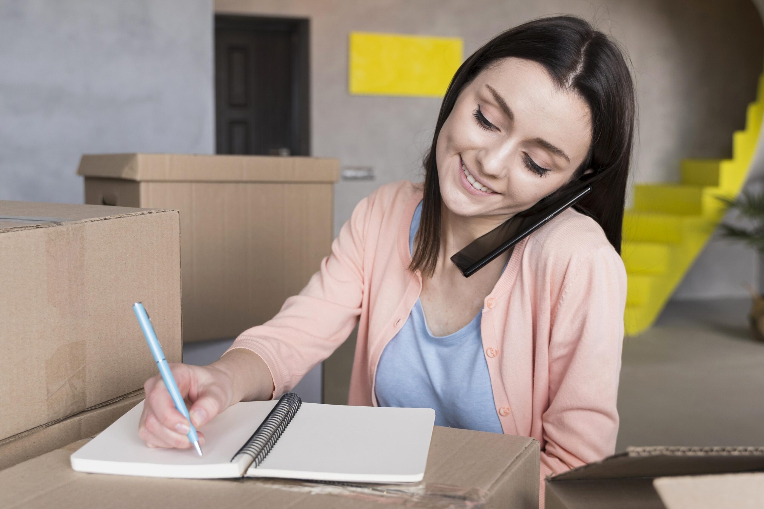 front-view-woman-preparing-orders-ship-while-talking-phone